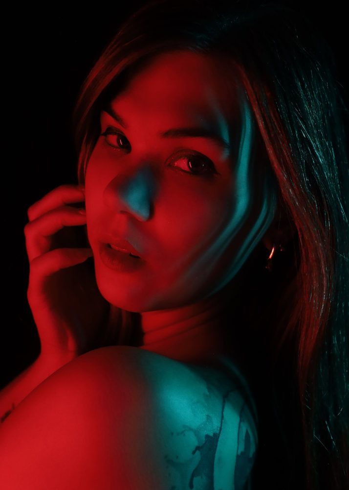 Portrait einer Frau in rotem und blauem Farblicht